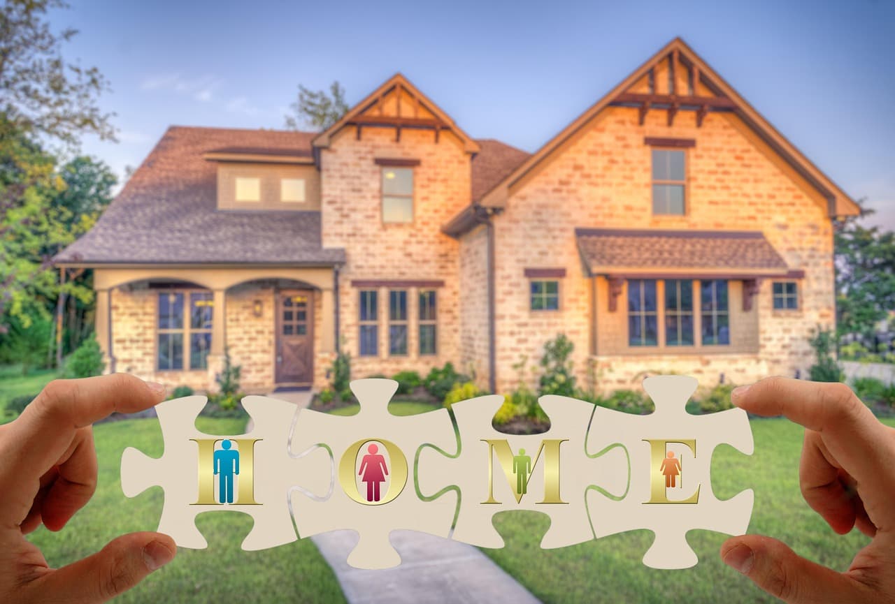 A family home, with the word home held up in front of it